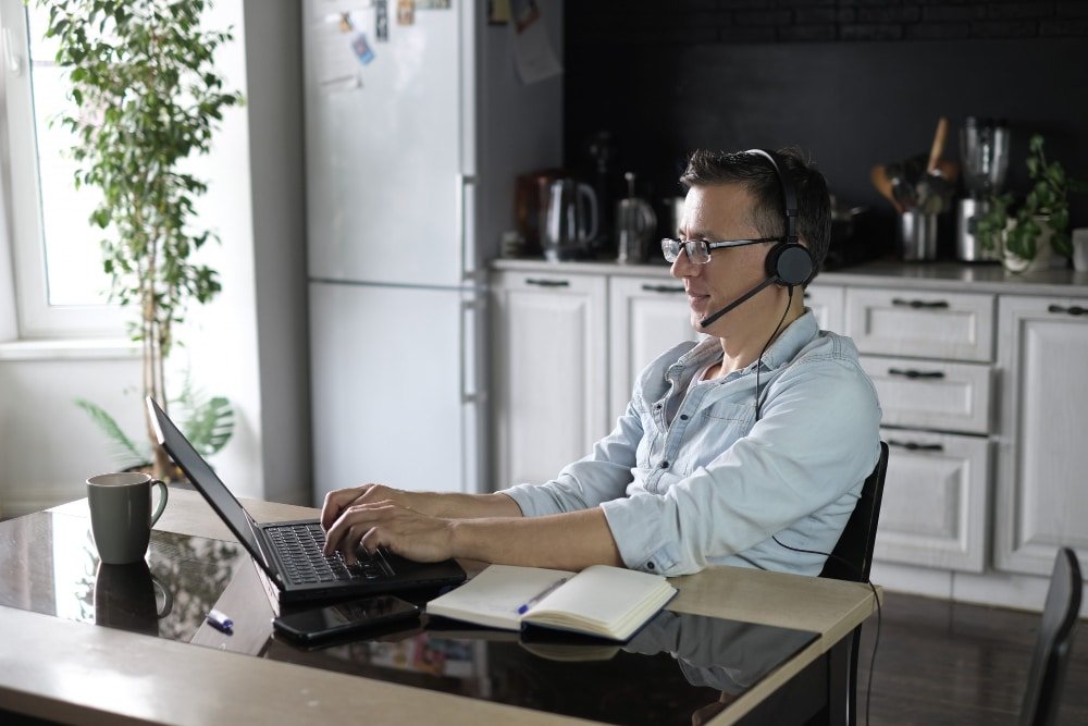Remote IT support professional in his office attending calls for remote support
