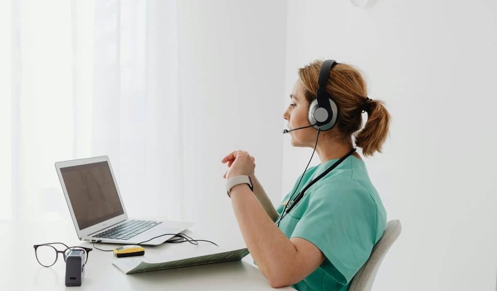 IT-consultant-providing-virtual-consultation-via-laptop-and-headset